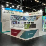 EverFocus booth at Embedded World 2025 in Nuremberg, presenting advanced solutions for a safer and smarter future powered by edge AI and intelligent industrial computers. The setup showcases cutting-edge technologies such as AI-powered vehicle surveillance, smart traffic systems, and smart warehousing applications. The display emphasizes the integration of NVIDIA Edge AI computers, demonstrating the potential of AI in transforming industrial operations. The booth's professional and modern design, alongside visual elements like vehicles and industrial applications, draws significant attention and highlights EverFocus's commitment to innovation in the field of AI-driven industrial computing.