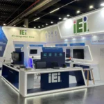The IEI Integration Corp. booth at the Embedded World 2025 trade fair in Nuremberg, featuring a sleek, modern design with prominent branding. The booth highlights IEI's innovative solutions in smart manufacturing and edge AI technologies, with a focus on reliability in challenging environments. Various technological products are displayed on counters for hands-on demonstrations, while multiple screens showcase detailed product information. The bright, professional layout emphasizes IEI's dedication to cutting-edge advancements in industrial computing and AI-driven technologies.